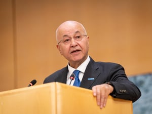 Barham Salih delivers a speech from a podium.
