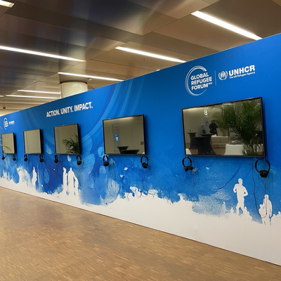 An installation of televisions set into a blue background.