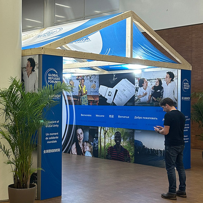 A tent structure featuring photos of refugees. 