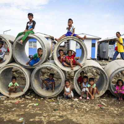 Young children pose for the photo on concrete structures.