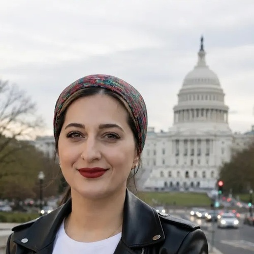 Basma Alawee pictured outside with a street in the background and a white building in the distance