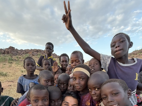Omar Farooq taking a selfie with children