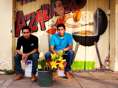 Mexico. Central American Refugees Jose Ismael and Leonel Antonio Diaz sell flowers in the streets of Tapachula, Mexico.