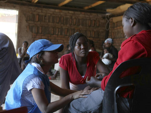 UNHCR staff with women and children in a protection shelter