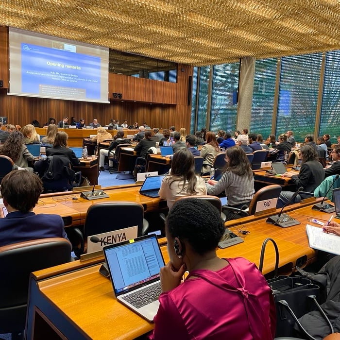 Attendees in a conference room. The large screen displays "Opening remarks: H.E. Mr Gustavo Gallón"