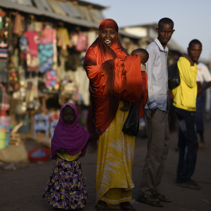 A Somali refugee woman and her children in the streets of Kakuma refugee camp.