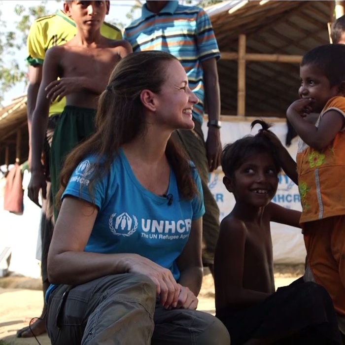 Kristin Davis smiling with several Rohingya refugee children