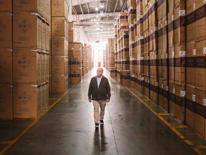A man walks in the middle of a warehouse