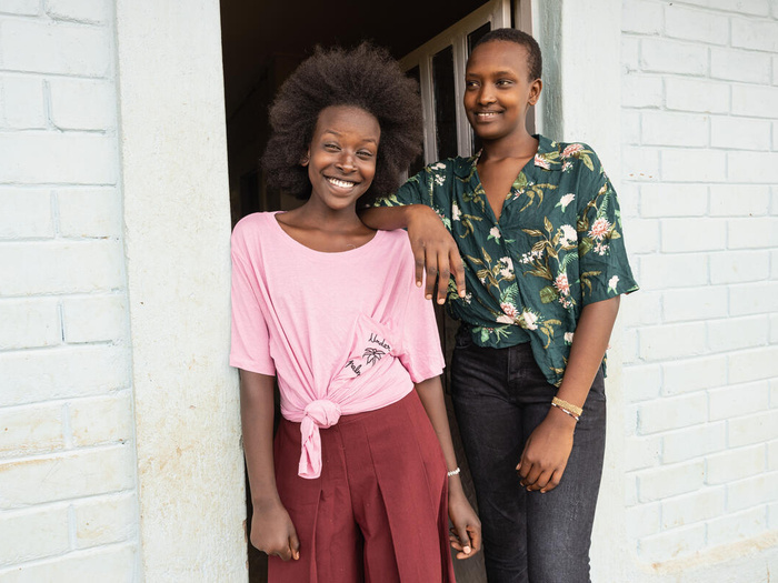 Two smiling sisters wearing clothing donated by Inditex
