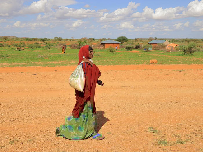 Ethiopia. Ilama Ahmed, 31, an Internally Displaced Person walks home with groceries she purchased from a shop owner, Ahmed Salah Ahmed in Darso camp for the Internally Displaced Person