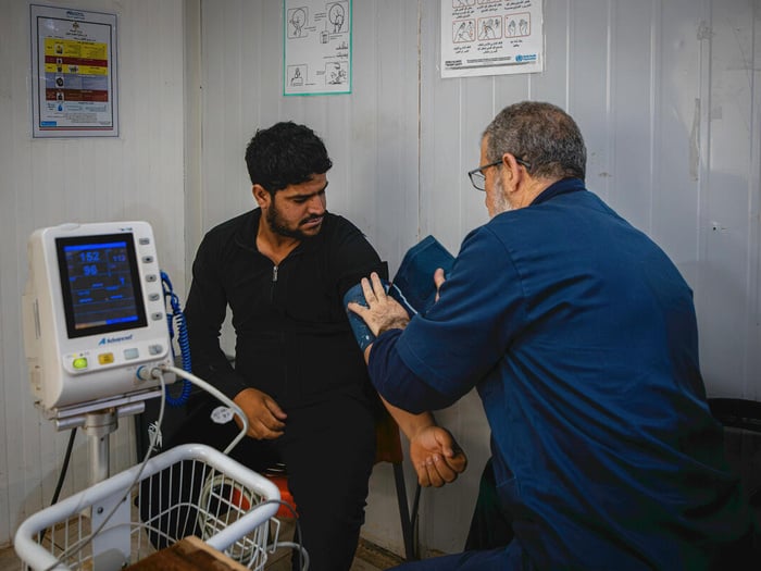 A doctor provides healthcare in Jordan.