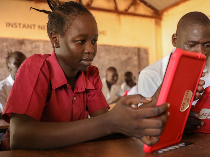 A student uses a digital tablet in a classroom.