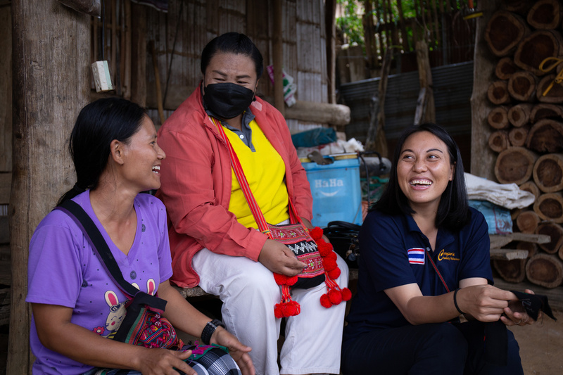 Meefah Ahsong shares a laugh with a colleague and one of the women she has helped to gain citizenship.