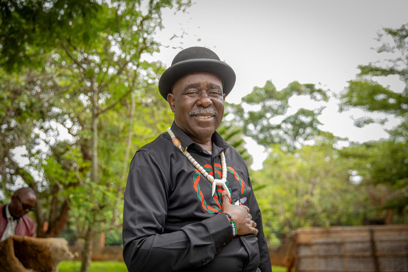 Daria, a Ukrainian refugee and biologist, uses a handheld machine to test soil in a crate.
