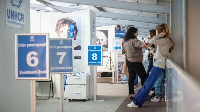 Refugee women from Ukraine are waiting in line to be registered for cash assistance