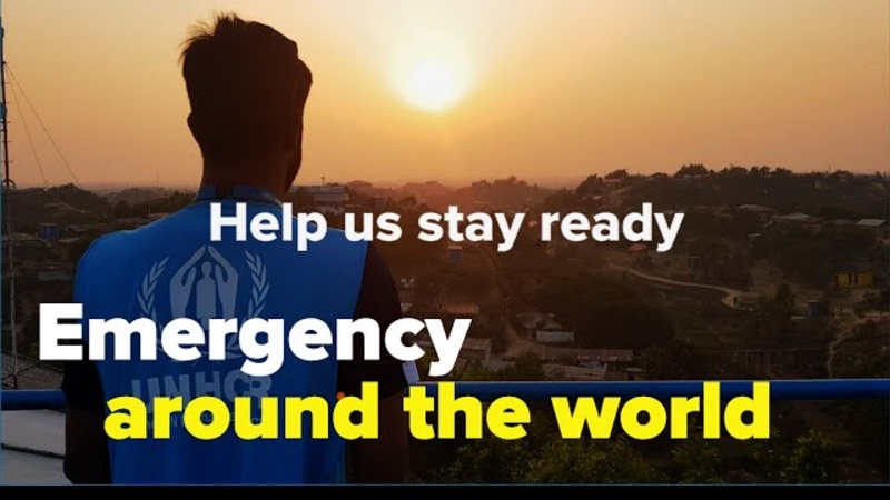 UNHCR staff member looks at the sunset. Text on image reads: "Help us stay ready. Emergency around the world"