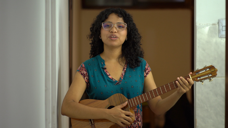 Cristina playing the cuatro