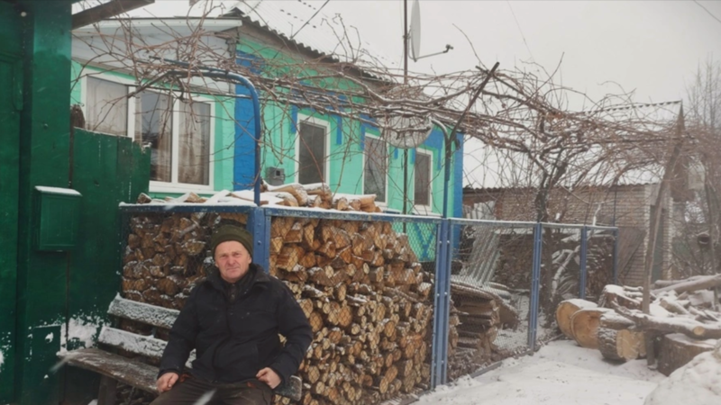 man sitting on a bench in winter