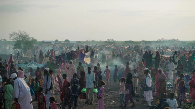 New arrivals fleeing the conflict in Sudan gather at the Joda border crossing in South Sudan in November 2023, awaiting onward transportation to the transit site in Renk.