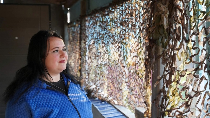 Olena, 30, sits inside her modest home in Kokhanivka village, Kherson region, Ukraine. 