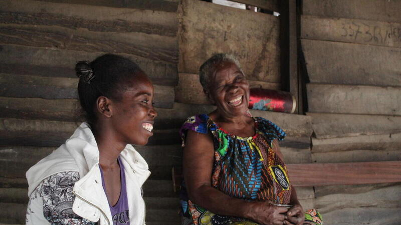Two refugee women laughing