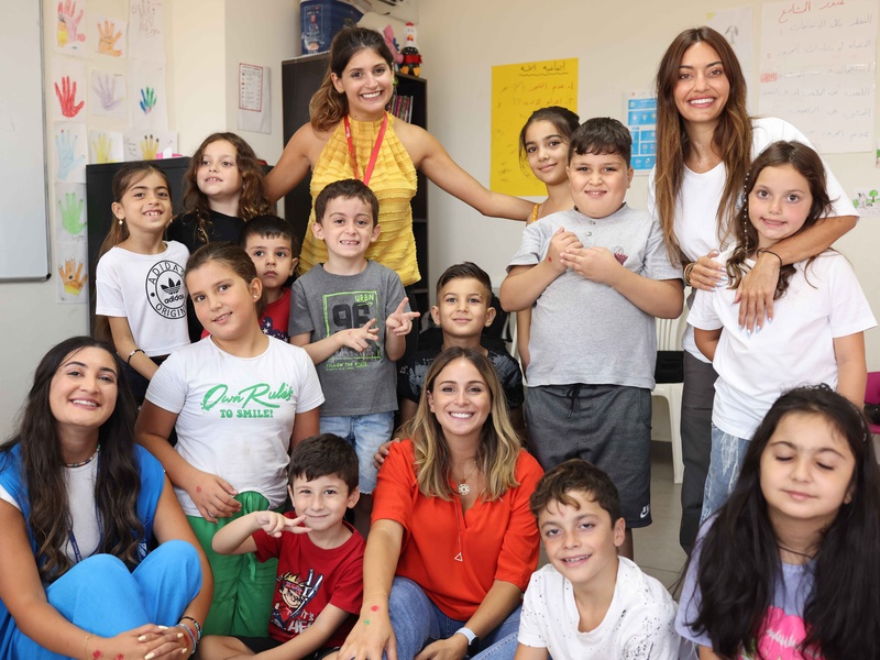 Karen poses for a group picture with her children and other young students.