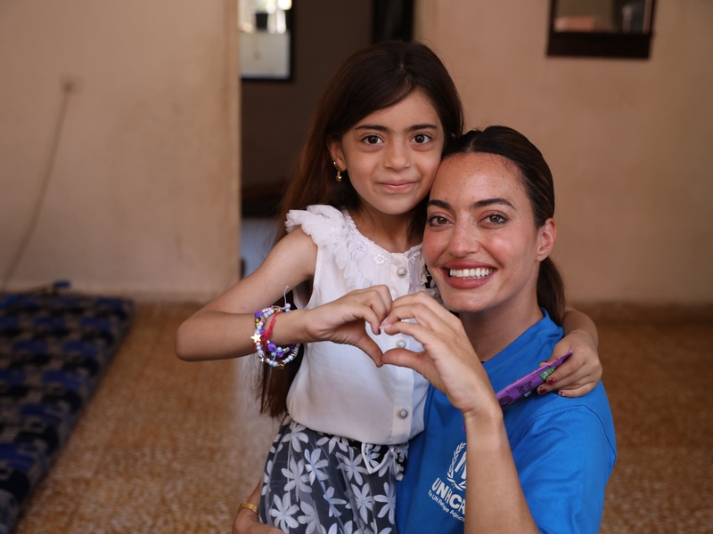 Karen Wazen and Rimas hugging and making a heart with their hands.