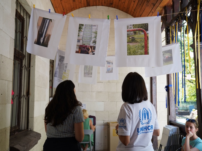 Valentina Naforniță looking at printed photographs