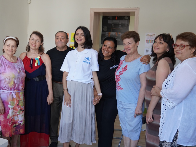 Valentina Naforniță poses for a photo with the local choir of refugees and local Moldovans