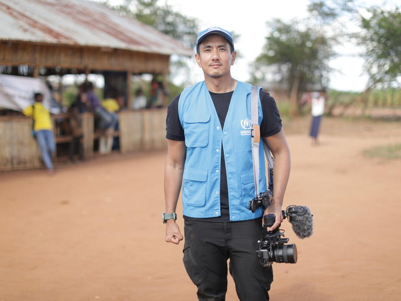 Wannasingh Prasertkul stands holding a video camera at his side