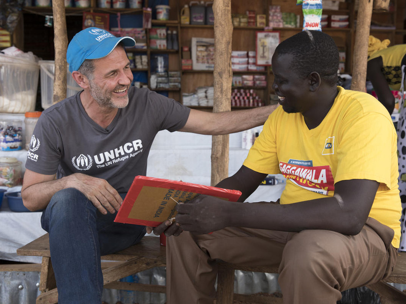 UNHCR Goodwill Ambassador Khaled Hosseini with South Sudanese refugee and entrepreneur, Jacob, at the market in Nyumanzi refugee settlement. 