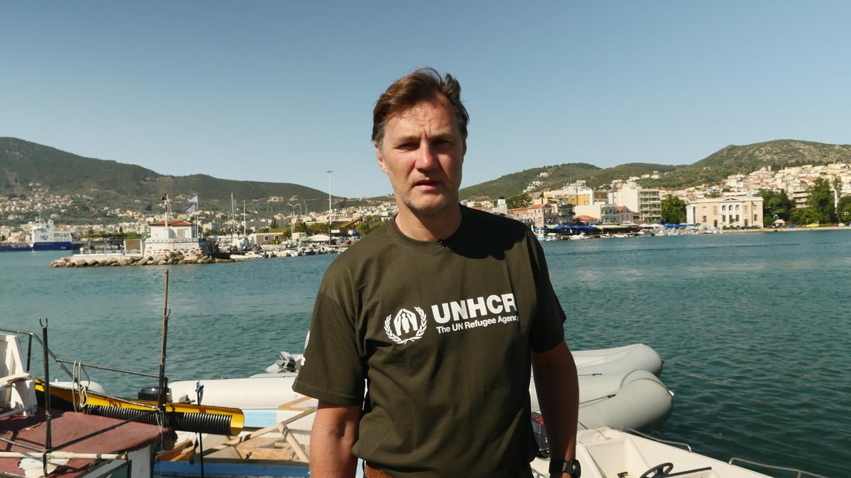 David Morrissey stands in front of the sea.