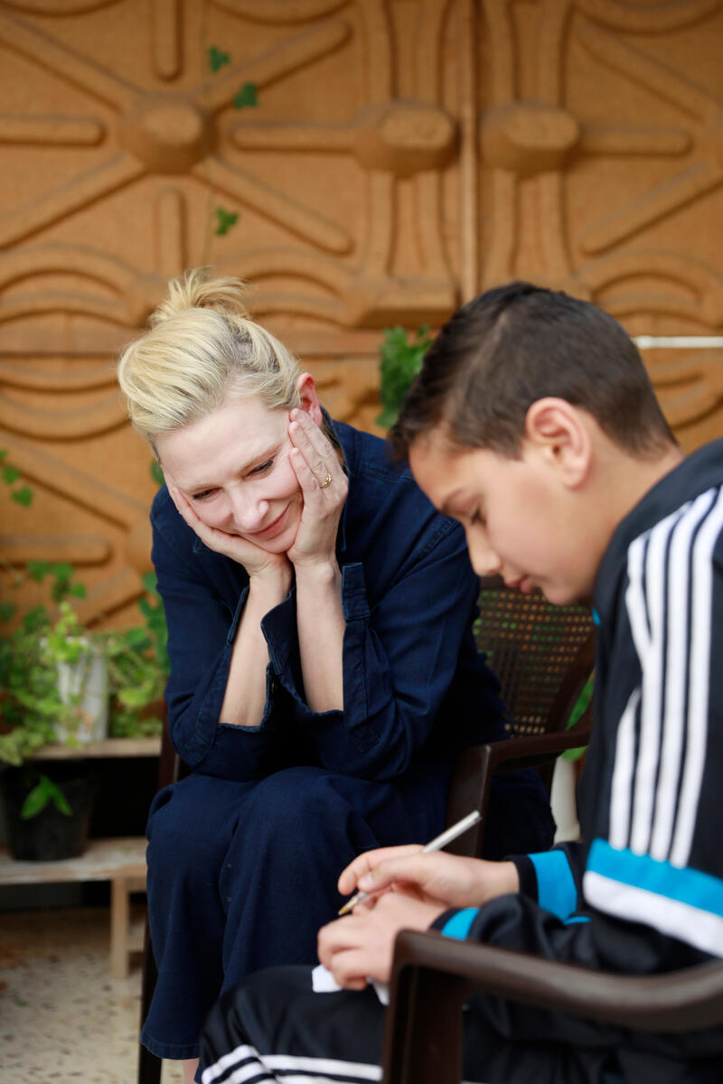 Yousef Harba, a boy of 11, shows his sketches to Cate