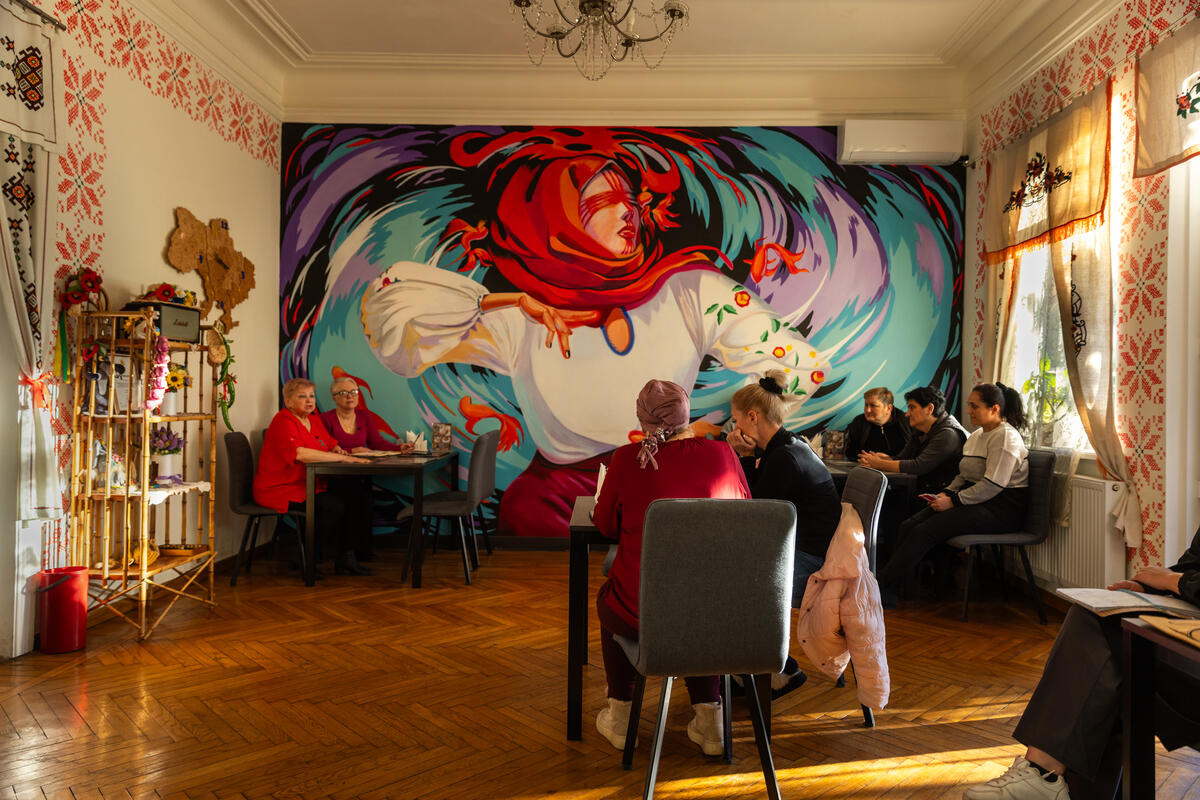 Employees in a bright, colorful café ahead of its opening.