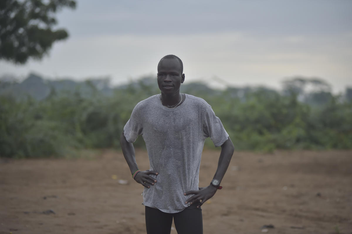 Yiech Pur Biel catches his breath, his hands on his hips.