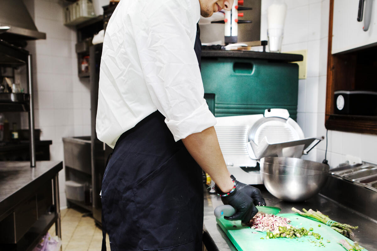 Spain. Unaccompanied Syrian refugee minor works in a local restaurant