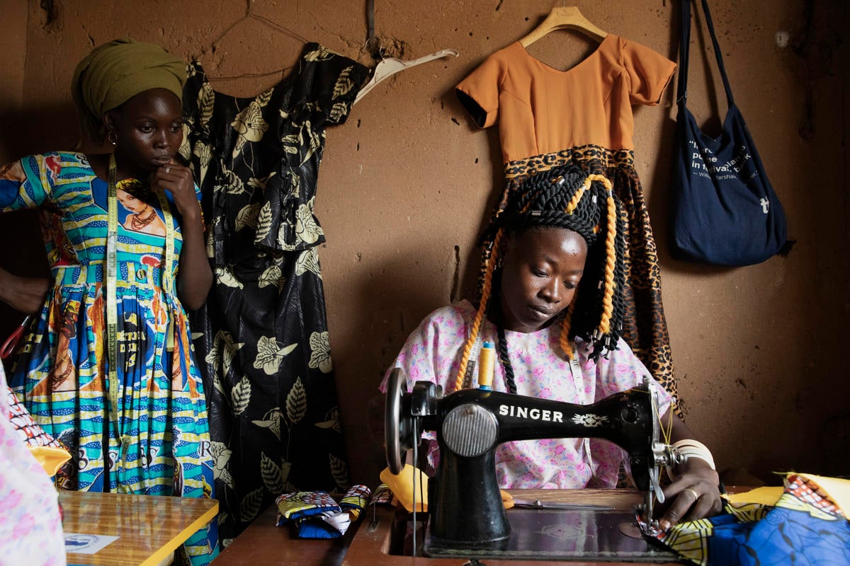 Central African Republic. A member of the "Standing Women" sews