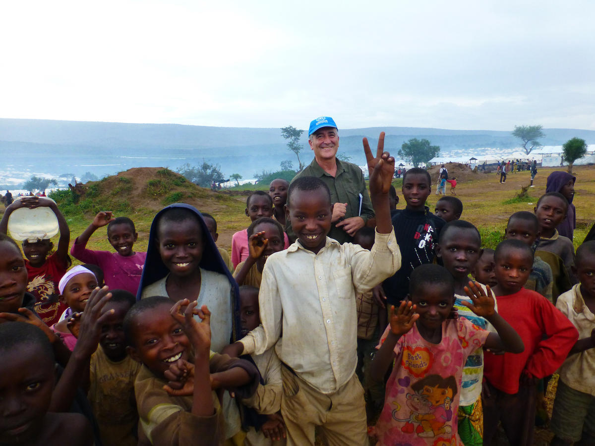 Rwanda. Head, UNHCR Supply Management Services, Vincente Escribano, with children.