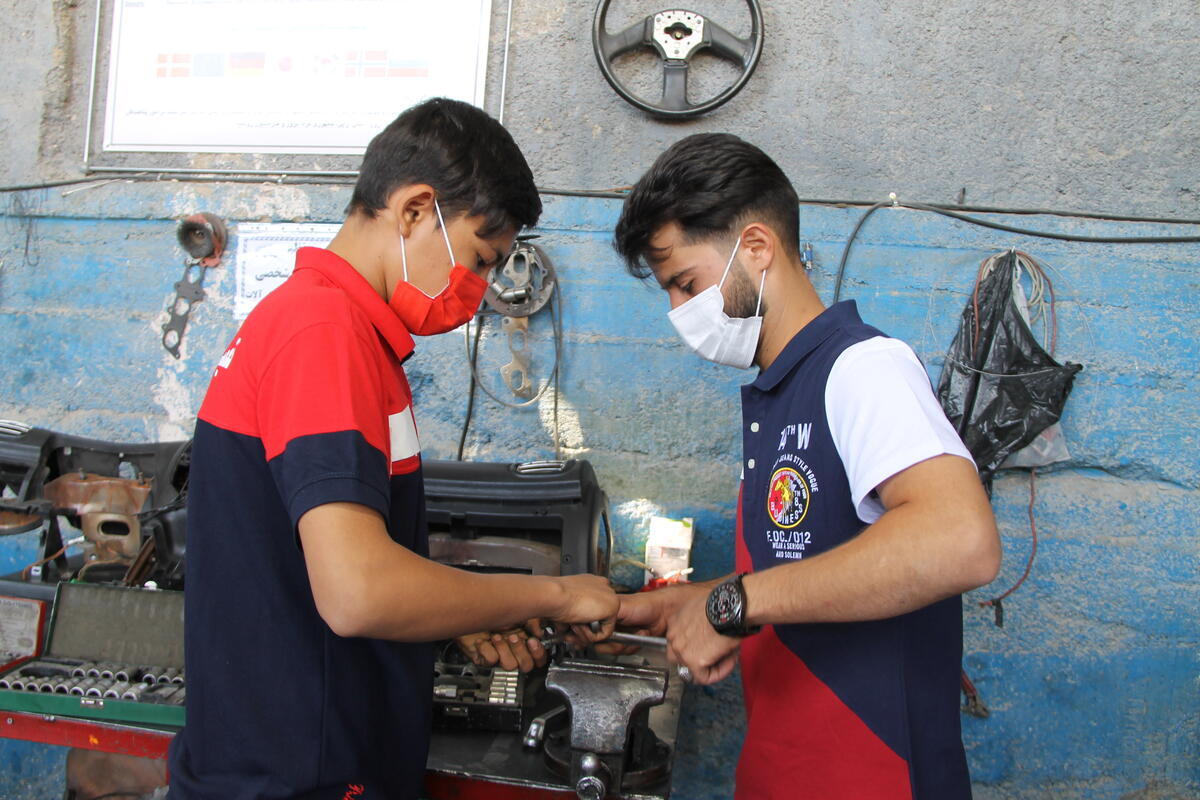 Iran. Iranian entrepreneur and refugee student in an automobile repair shop