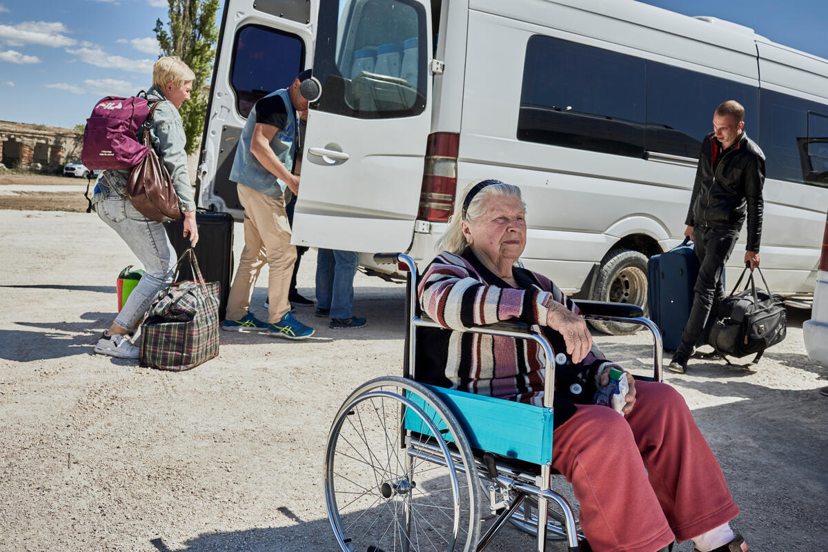 Moldova. Wheelchair-bound woman received by UNHCR at border crossing