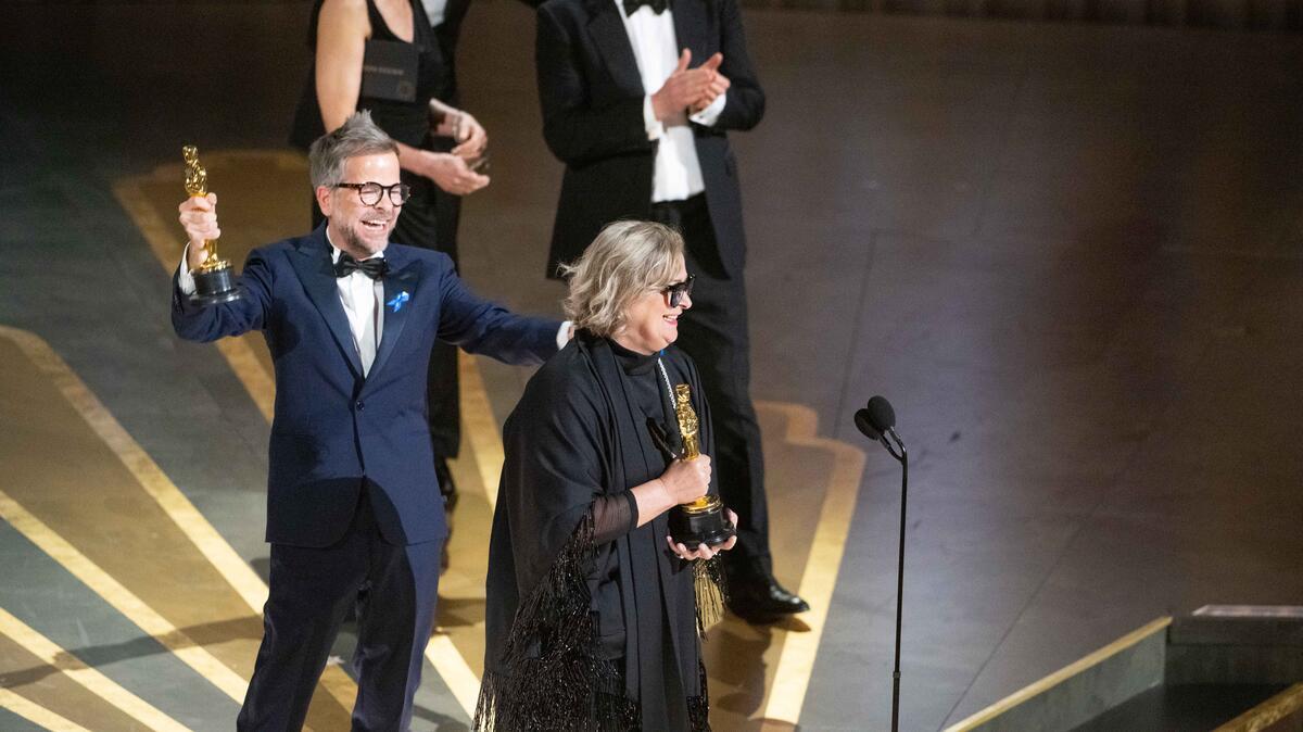 United States. Christian M. Goldbeck, Ernestine Hipper accept the Oscar for Production Design during the live ABC telecast of the 95th Oscars and wear blue ribbons in solidarity with refugees