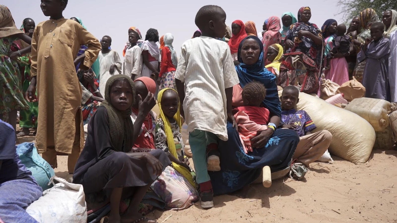 Refugees from Sudan gather near the border after crossing into Chad.