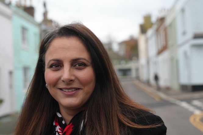A woman standing in the middle of a street