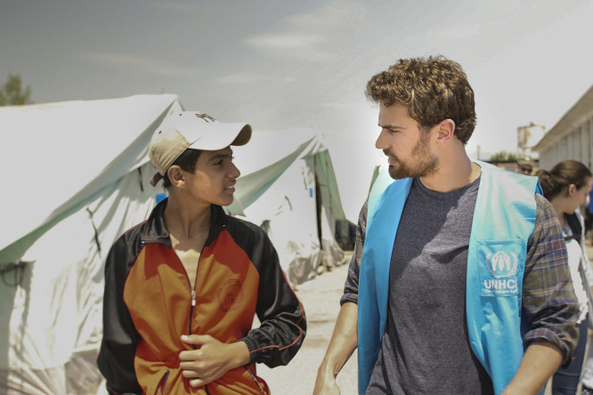 Theo James speaks with a teenage boy from Syria.