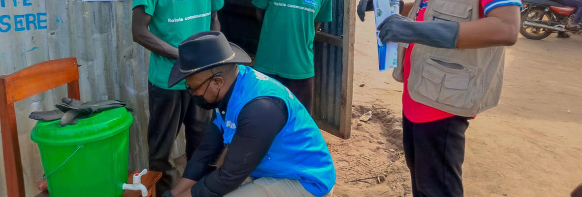 UNHCR staff inspect a chlorinated handwashing station