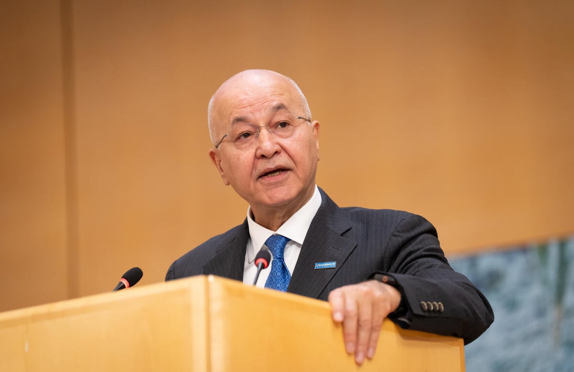 Barham Salih delivers a speech from a podium.