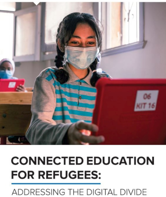 A young student, wearing a mask, sits at her desk and stares at her laptop's screen