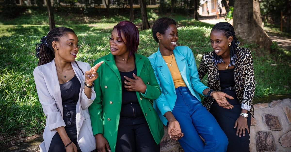 A group of refugee women standing together, their faces a mix of determination and sorrow