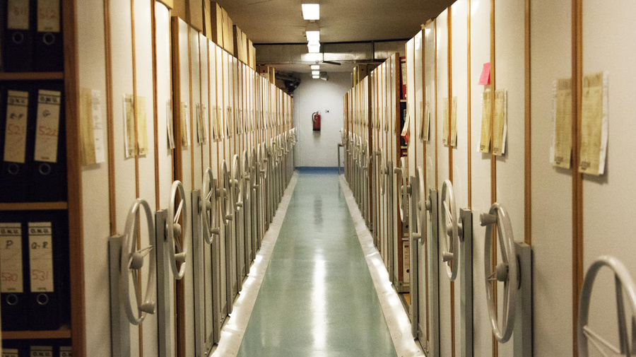 A view along a corridor of rolling stack archive shelves