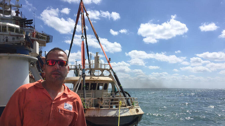 Egypt. Diver Emad Fath El Bab with Rosetta boat